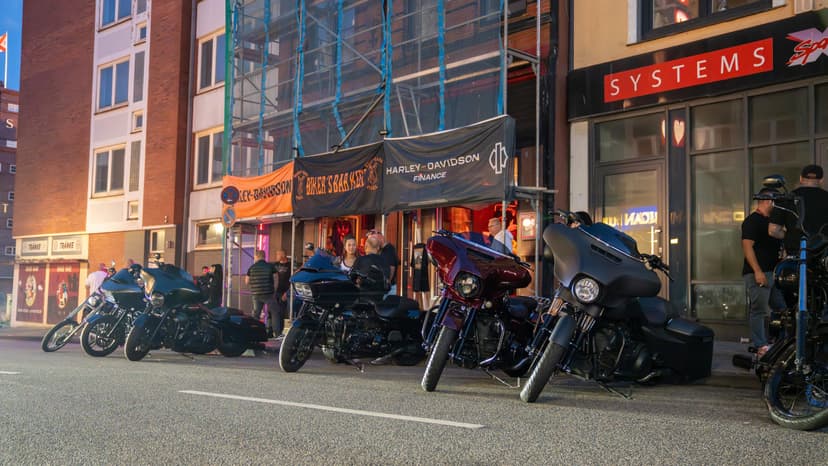 Reihe geparkter Harleys vor der Biker's Bar Kiel in der Abenddämmerung